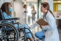 Patient in wheelchair with doc