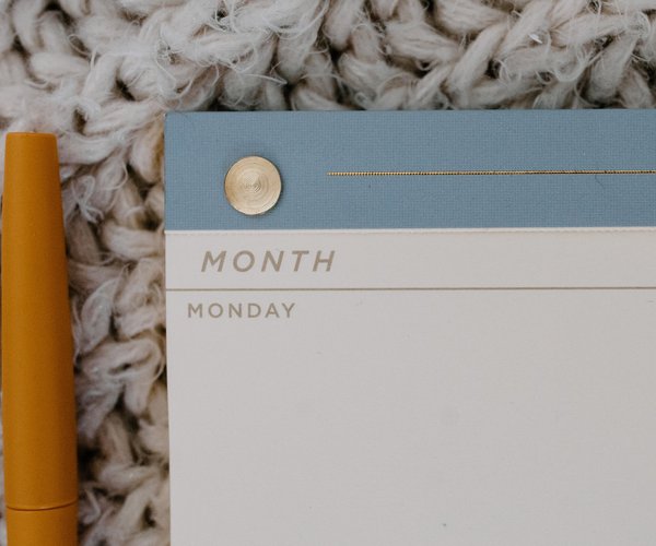 weekly planner and pen